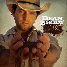 Dean's album cover, Dirt. It features him standing with his hands outstretched, holding a handful of earth, which is trickling through his fingers.